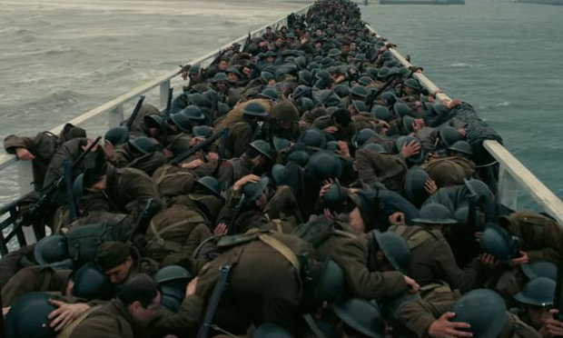 1,500 extras, a crane and a spitfire were used to recreate the miraculous evacuation of 338,000 allied troops. (image via warnerbros)