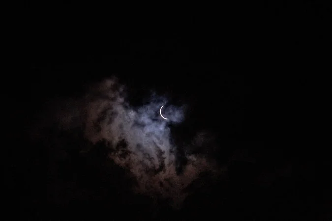 "Cloud coverage starts to clear as the eclipse approaches totality." (image via Andrea Morales for The New York Times)