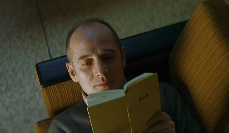 Ulrich Mühe enjoying his stolen literature.