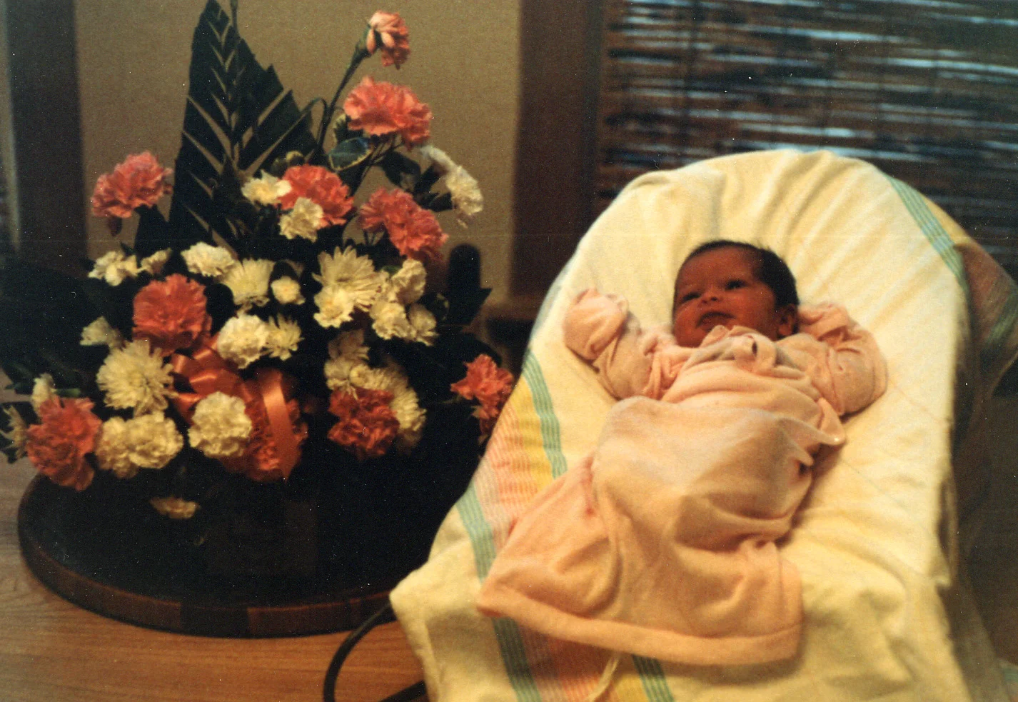 048 in gown next to flowers - 2-3 months.jpg