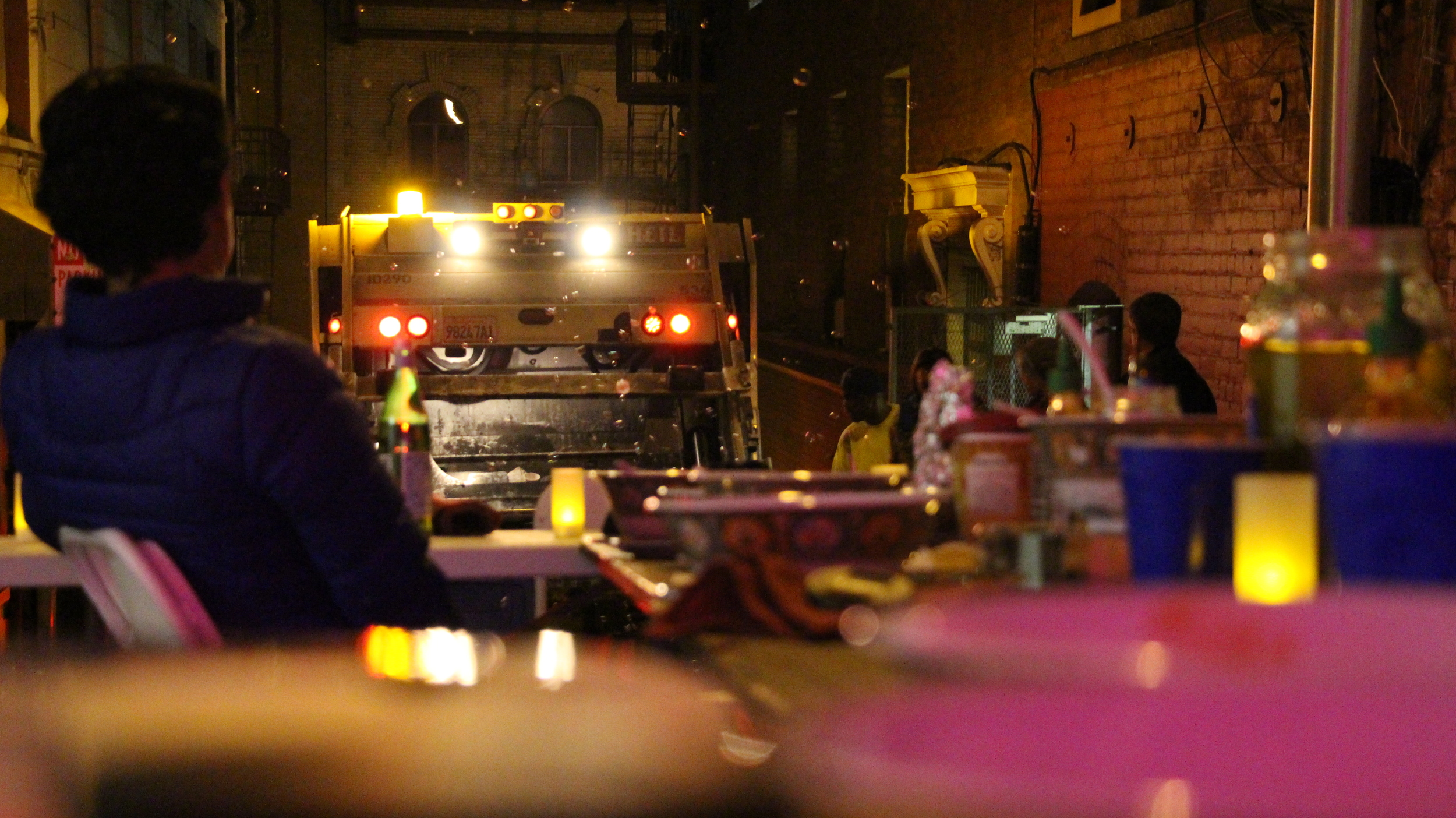 Watching the trash get compacted over wine and bubbles (we had a bubble machine)