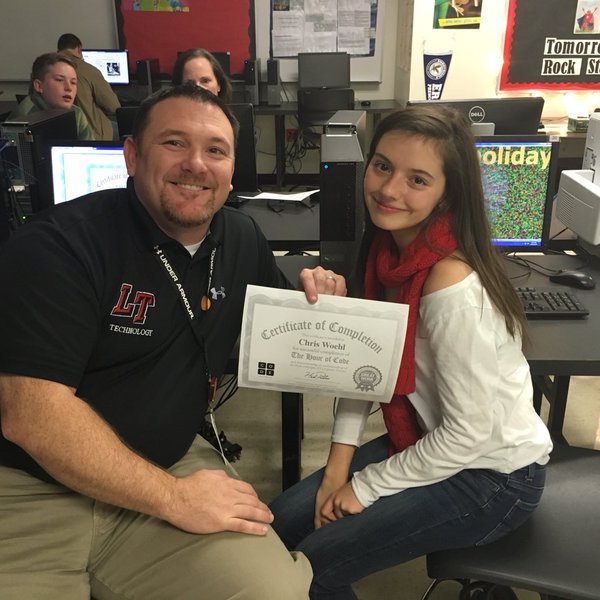 LTHS student Aria Nicolai helps Chris Woehl, LTISD Executive Director for Technology & Information Systems Services, complete an hour of code. 