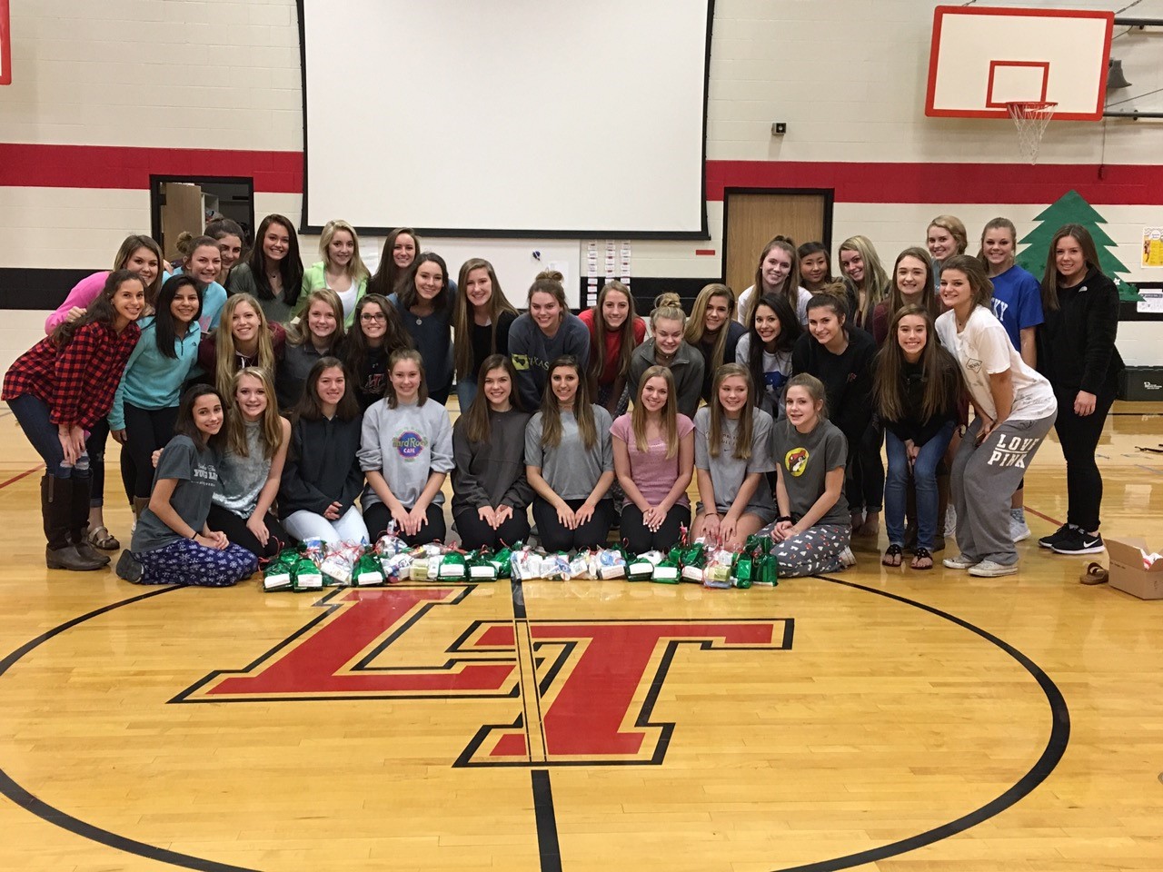Junior varsity and varsity cheerleaders display their gift bags for Mobile Meals of Lake Travis.