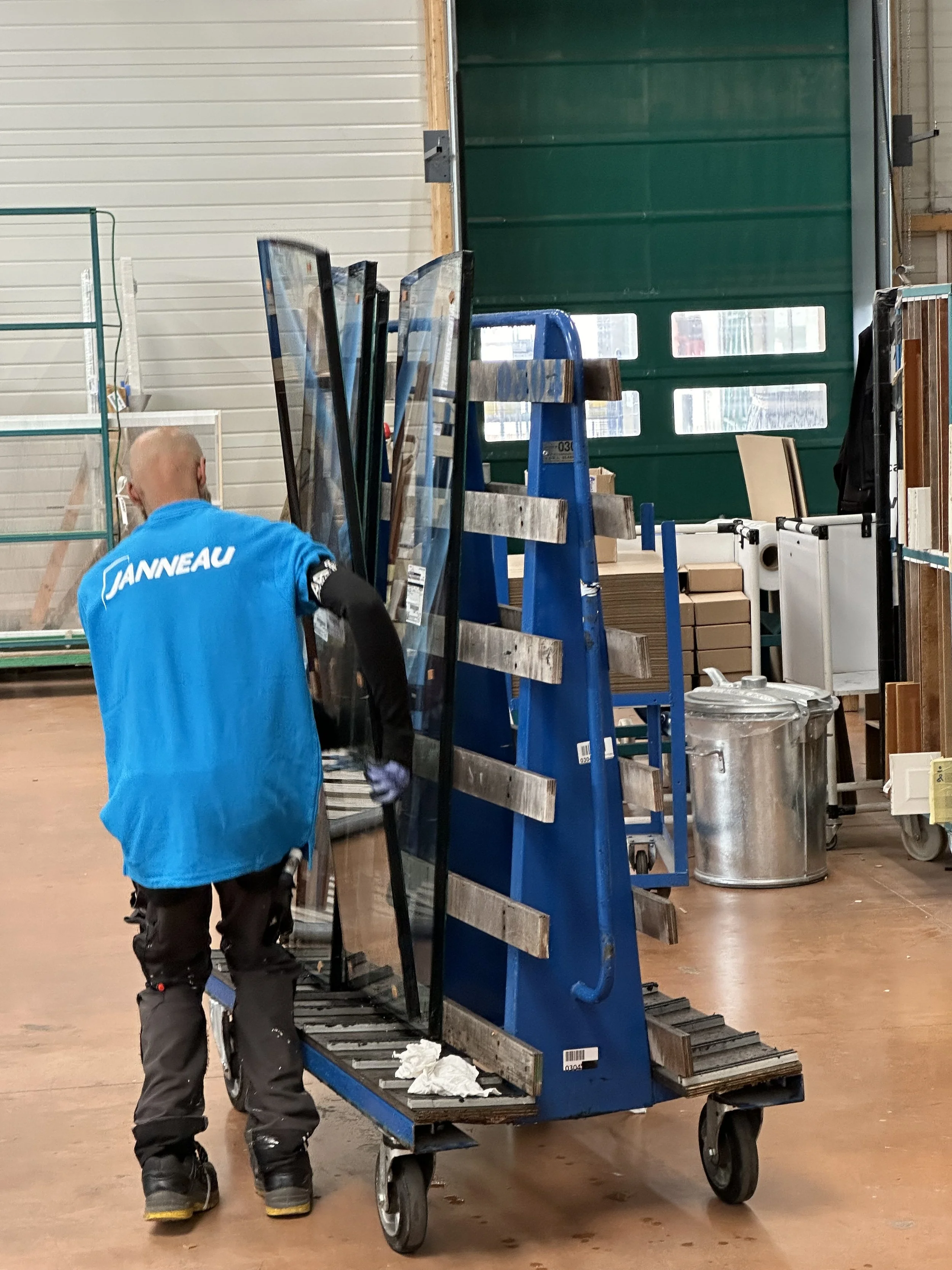 Maison Janneau Factory Tour Employee with a Cart Transporting Glass Panes for Assembly