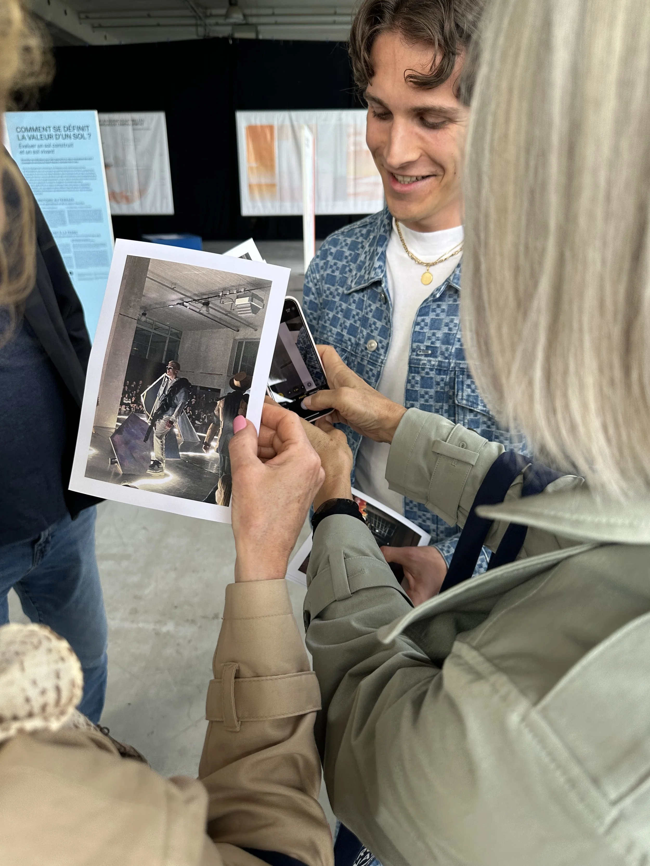 Lacaton And Vassal ENSA Group of Architects Holding Images of a Fashion SHow which Took place inside the space they are in