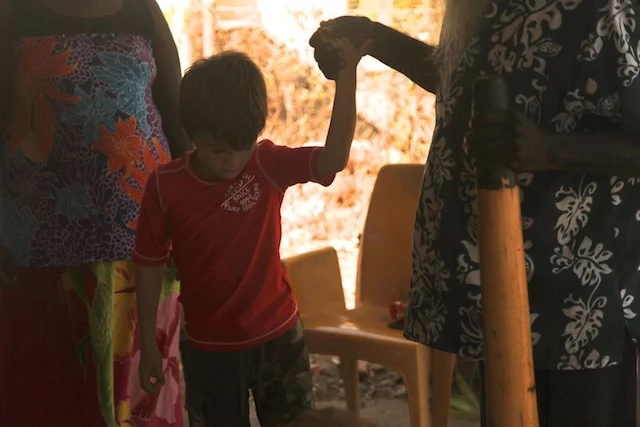  Bipi Djalu walking hand in hand with Ryder after offering healing on his broken leg