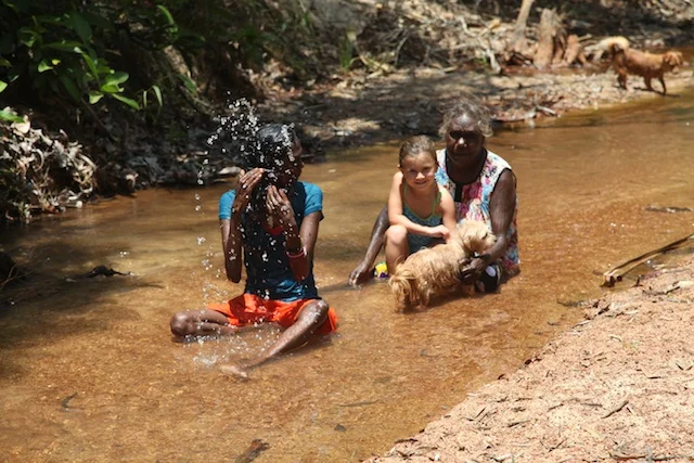  Amala and Cousin bathing with X in the sacred waters of Guanna Lagoon after a day of cutting yidaki