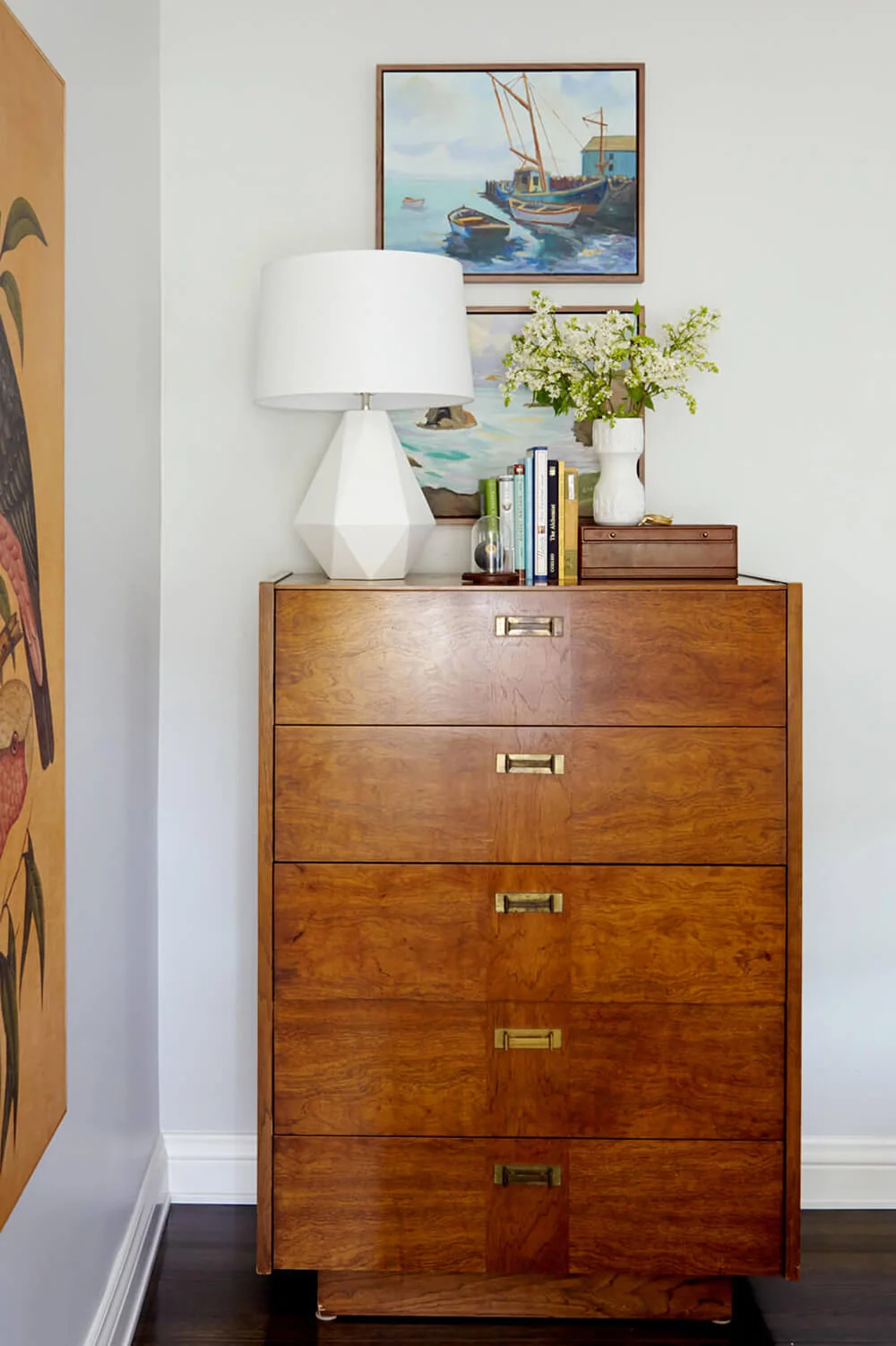 A Mid-Century nook by Emily Henderson Design incorporates another design trend for spring: realistic faux florals.
