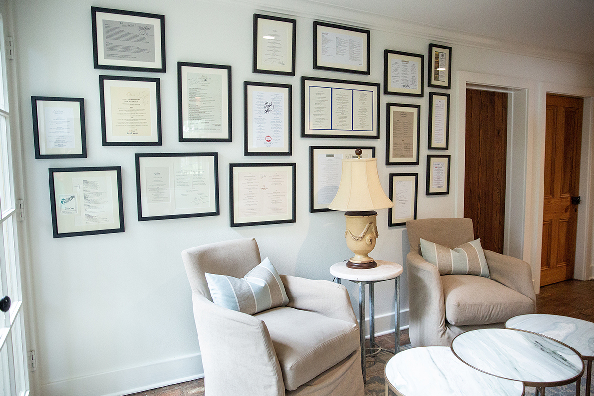 In this seating nook alongside the homeowner’s kitchen, the design team used framed, autographed menus from favorite restaurants to add interest and individuality.