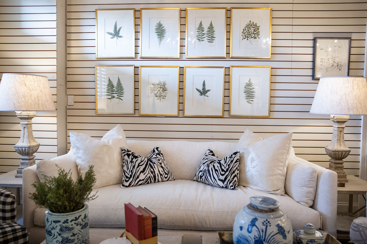 A winning combo of matching lamps, custom upholstery and unique botanicals creates an inviting vignette.