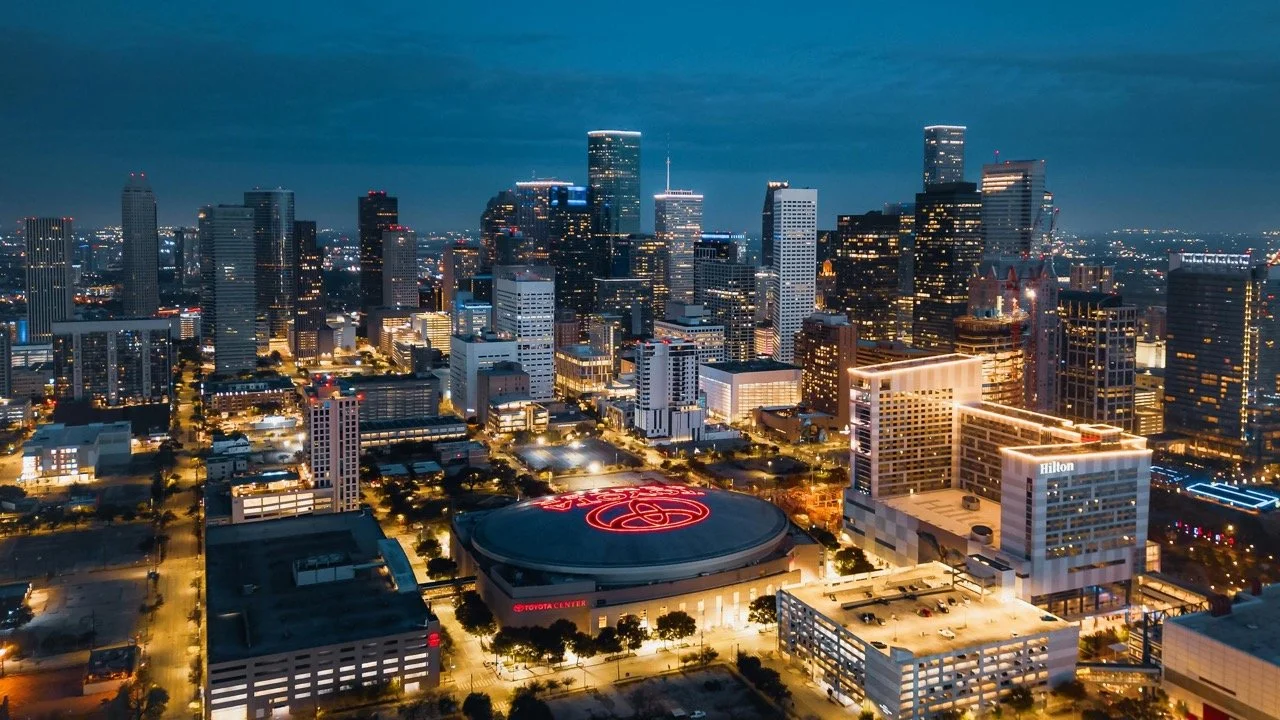 The Houston skyline at night with the Toyota Center