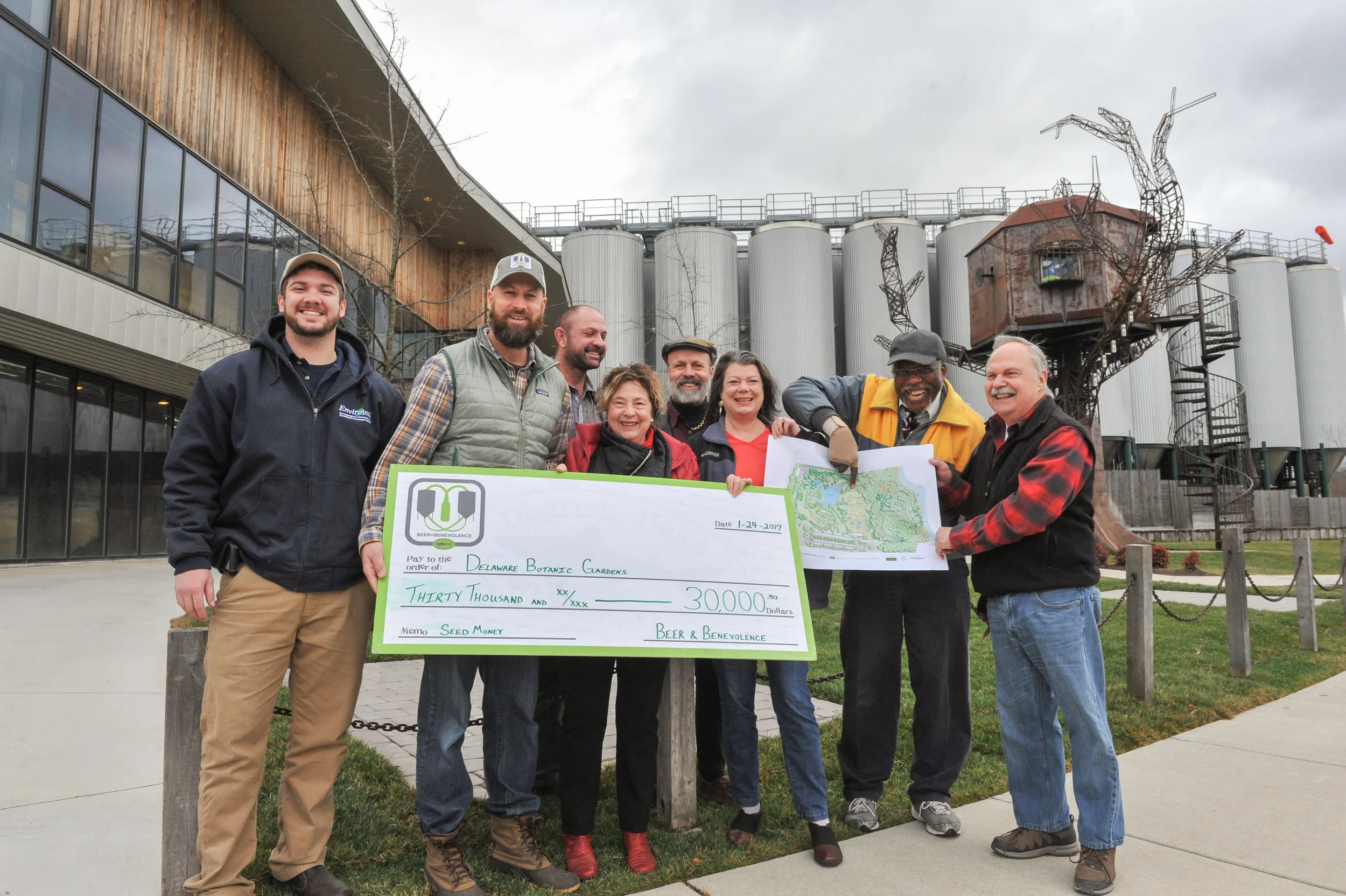  Mark Carter (second from left), director of Dogfish Head’s Beer & Benevolence program, presents the company’s $30,000 pledge to the Delaware Botanic Gardens at the brewery in Milton. Tyler Hammond, director of operations for Envirotech Environmental Consulting, is at the far left. They are joined by DBG leaders (from left) Gregg Tepper, Sheryl Swed, Henry DeWitt, Janet Point, Peter Carter, and Raymond Sander. Photo courtesy Dogfish Head Companies