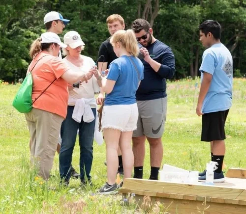 Teachers Ryan Revel and Kristen Ables with students Photo by ray bojarski