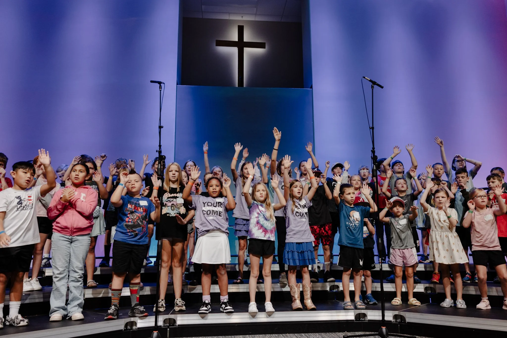 Kids on statge with hands in air .jpeg