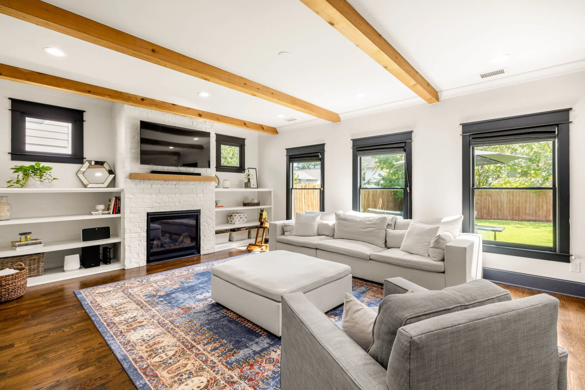  Family room with white brick fireplace and built-in bookcases 