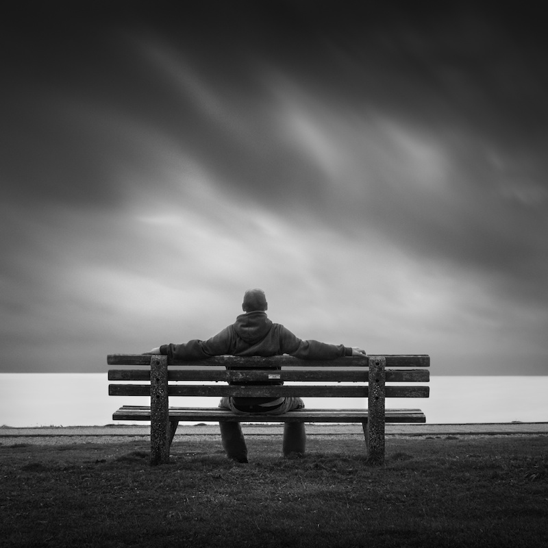 man-waiting-on-bench.png