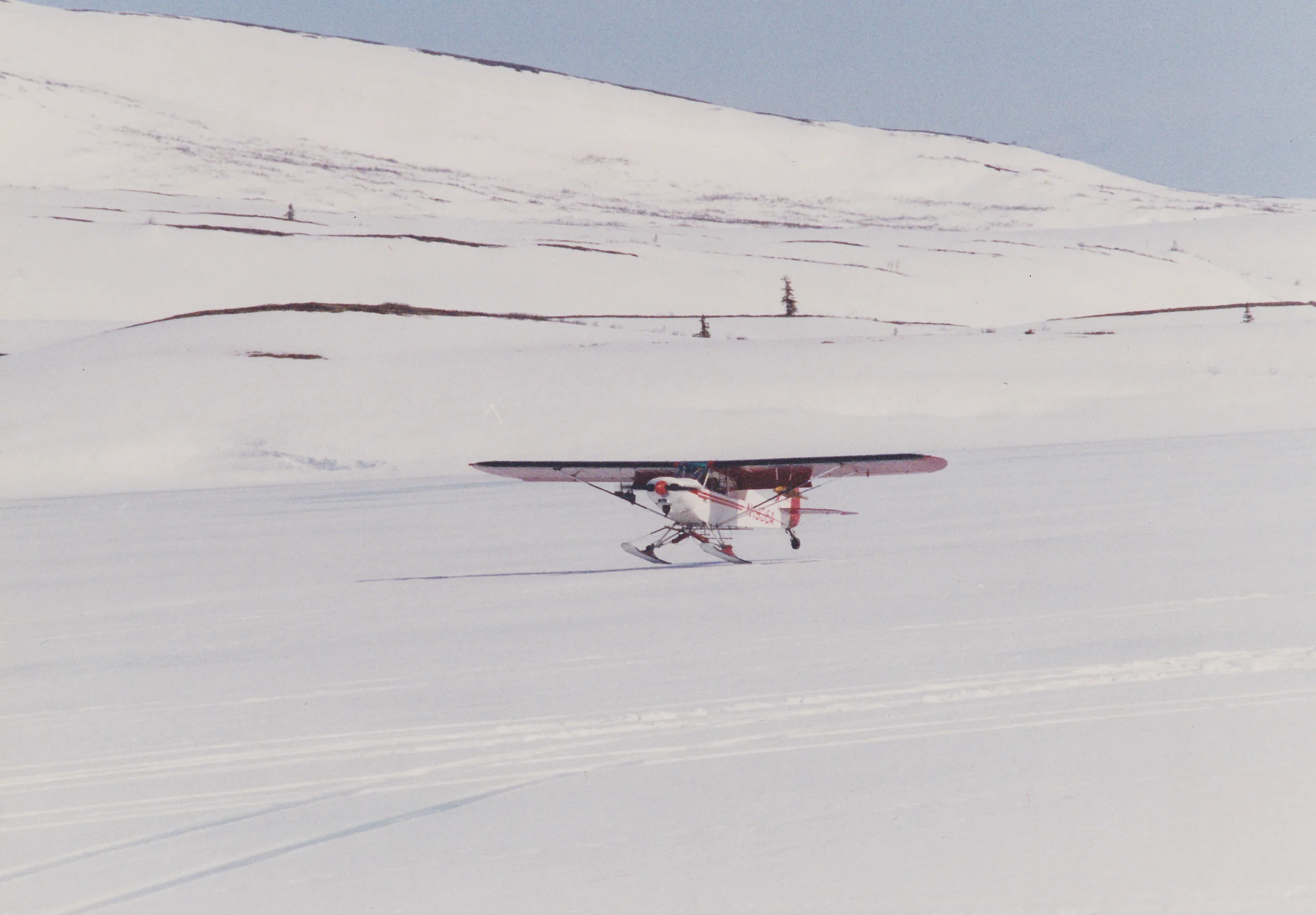 Landing on skis at a frozen Otter Lake during spring brown bear season. Photo was taken by one of our spring hunters, Ken Farrier of Torrington, WY