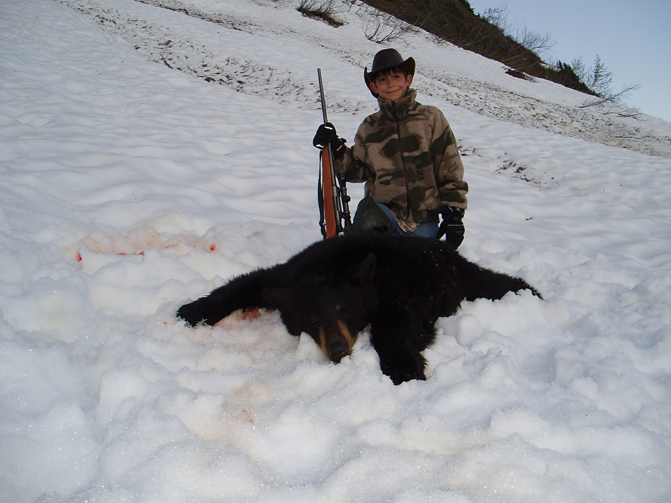 Grandson Jared Juliussen 11 years old with his first black bear. It took us two hunts to get his bear and it was a 5'7". Jared up-graded a few years later with a 6'5".