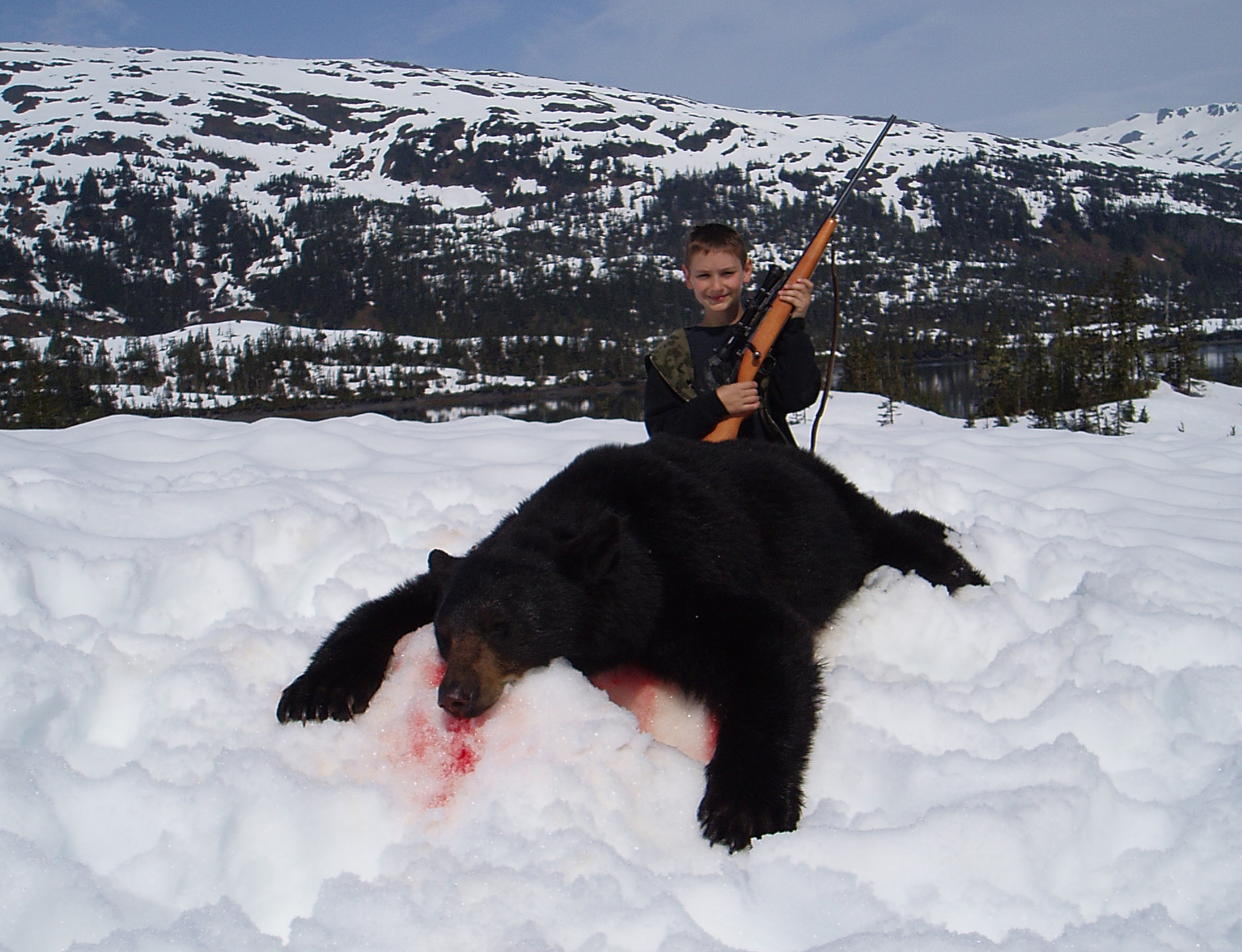 My grandson Nathan Juliussen age 10 with his 6'5" bear. It was taken about 25 yards from where Jared shot his first bear. Nathan was the youngest to take a bear.