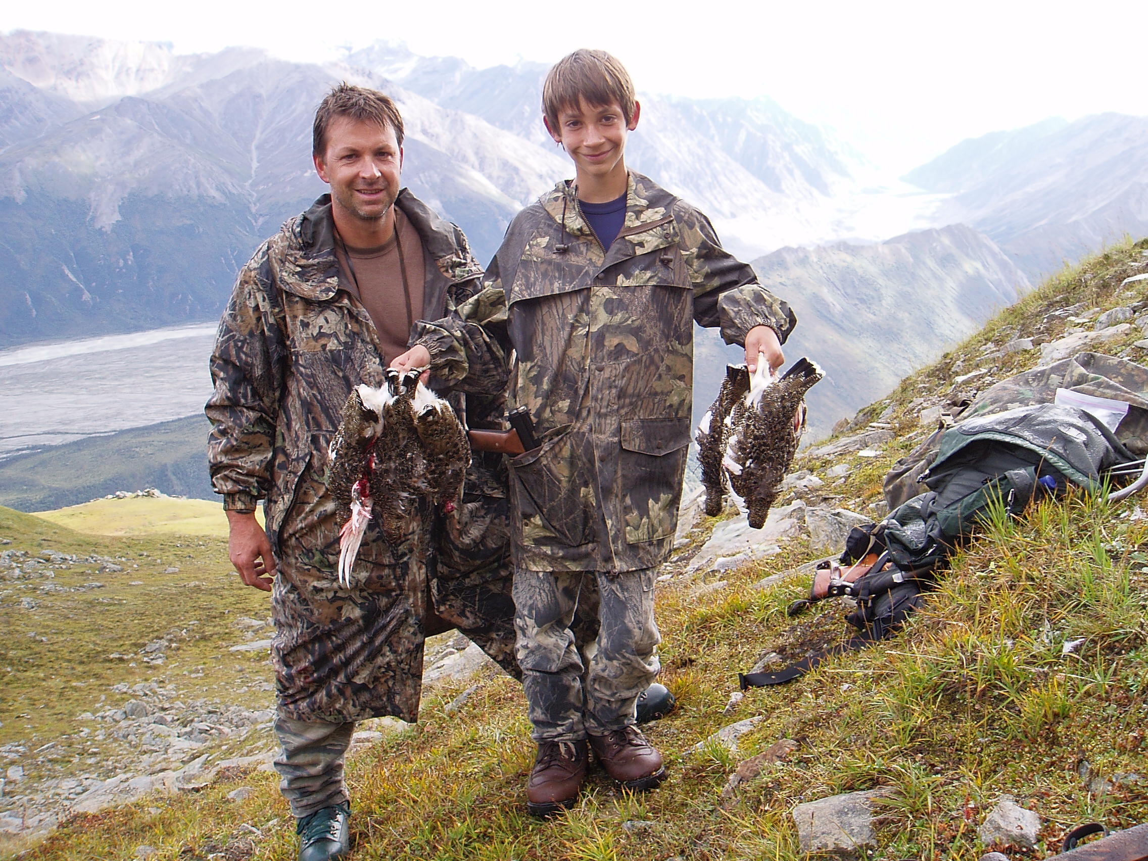 Jared with his dad Sagen getting supper with his .22 pistol.