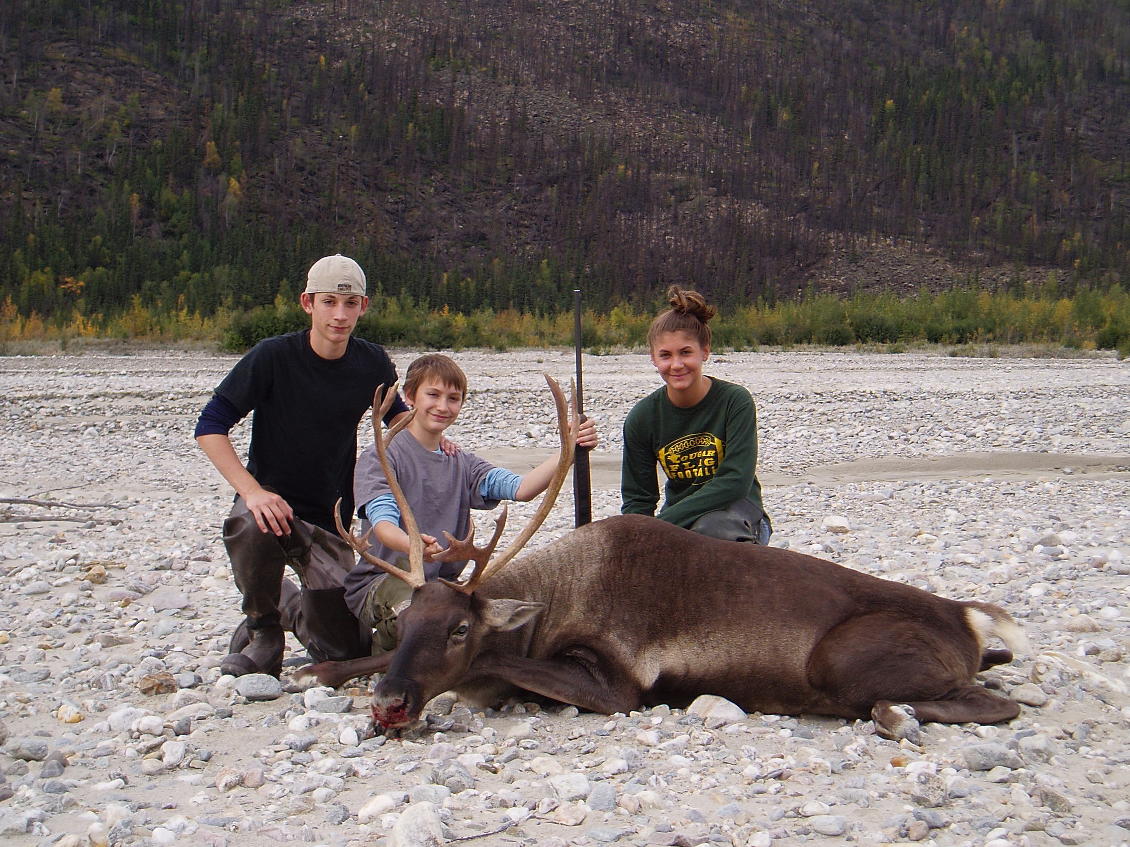 Nathan with his meat caribou surrounded by his brother Jared and sister Rachel.