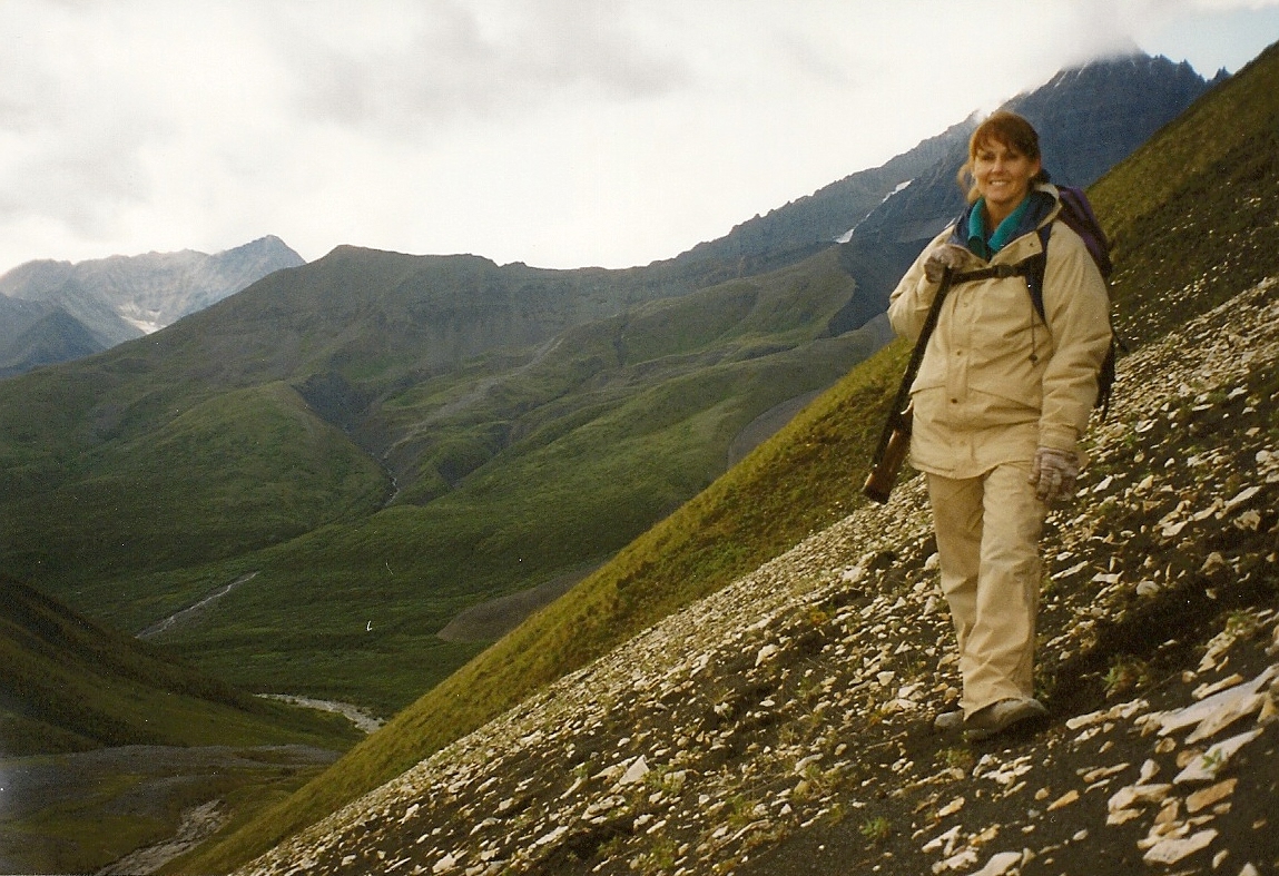 Karen climbing with Young Creek in the background.