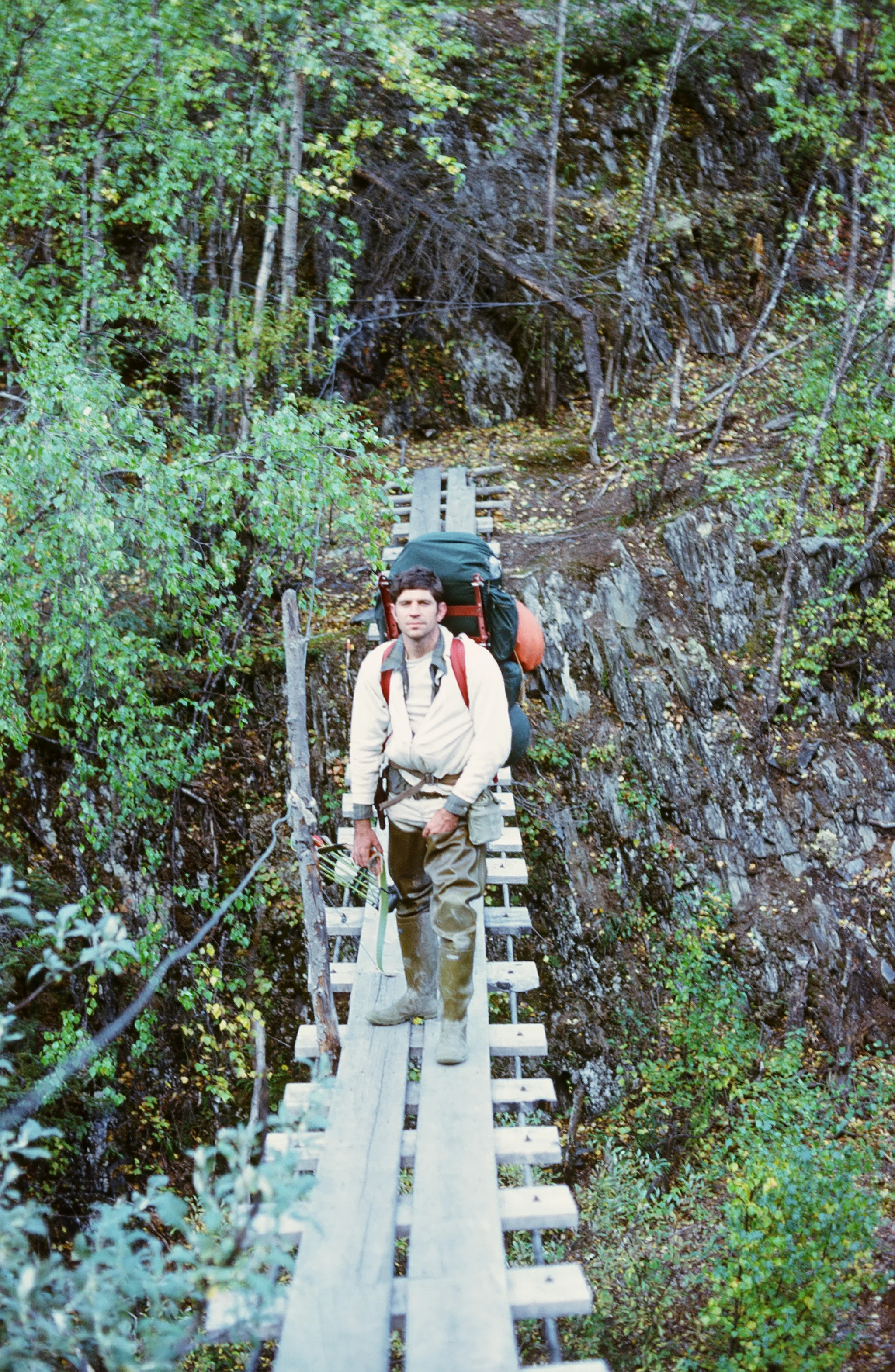 Me on the swinging bridge on a hunt in the early to mid 70's. One of the top cables is gone.