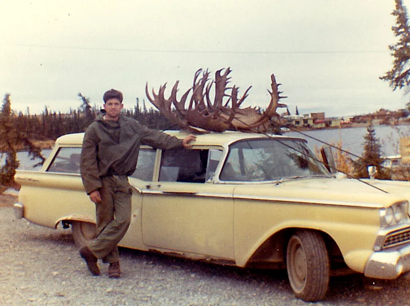 Me and my 59 Ford Station Wagon loaded with two moose and three caribou. Lake Louise is in the background.