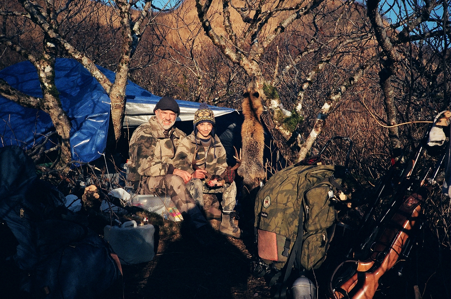 Jared and me at camp with his fox skin and deer antlers.