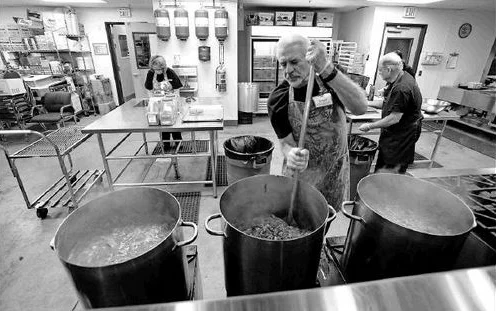 I'm stirring the moose burger into the chili in one of the three 20 gallon pots. When I'm finished the chili will be about 1" from top of all three pots.