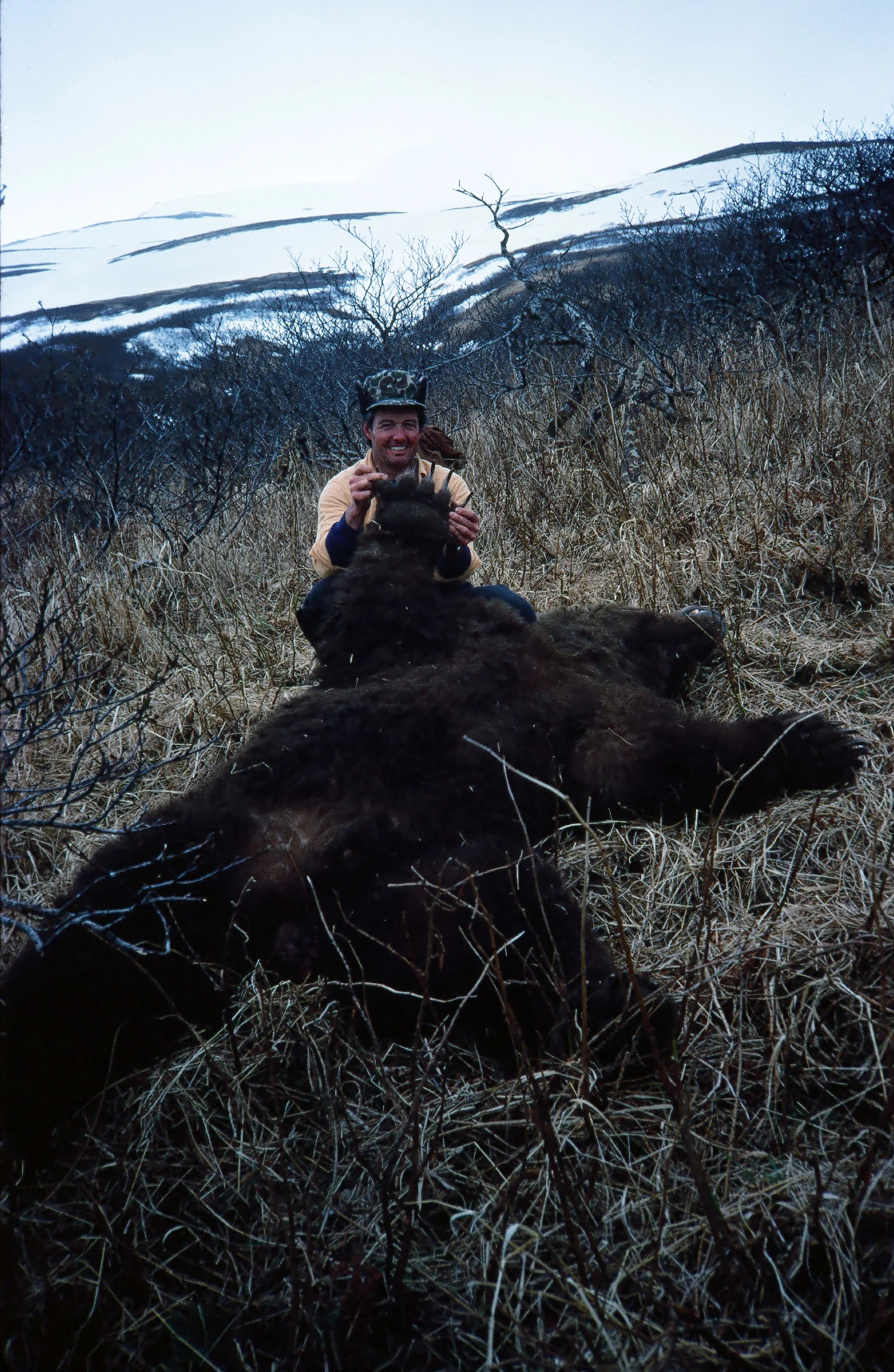 John's a happy hunter showing the bear's enormous paw.