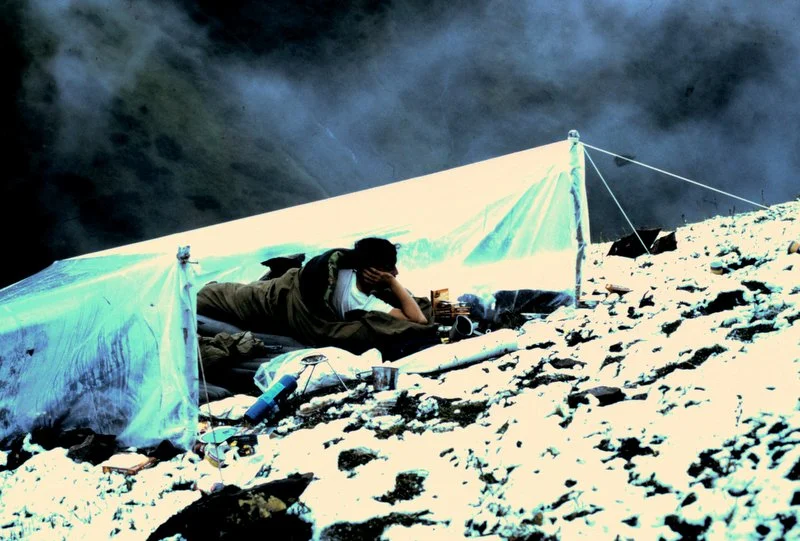 Skip Phillips relaxing in our hillside camp in the snow.