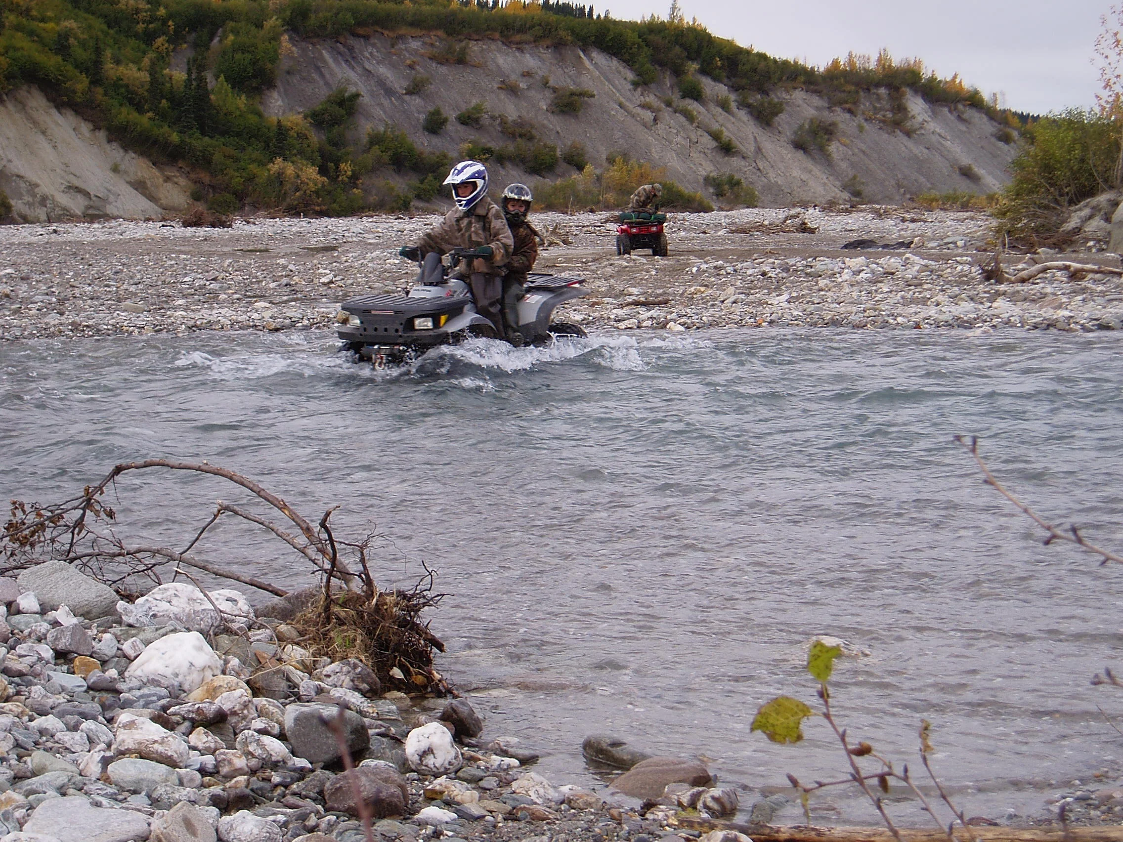 Jared and Nathan riding double on a normal creek crossing. Sagen is in the background.