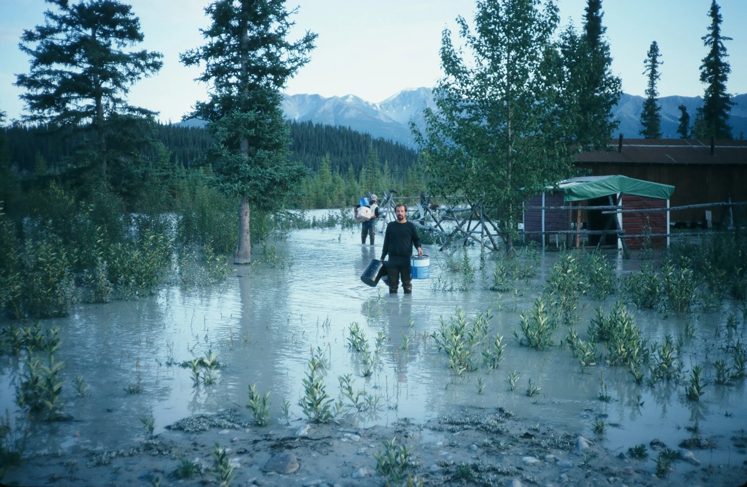 Dee, Dan and me carrying gear from the cabin to a place we could land, about a mile away.