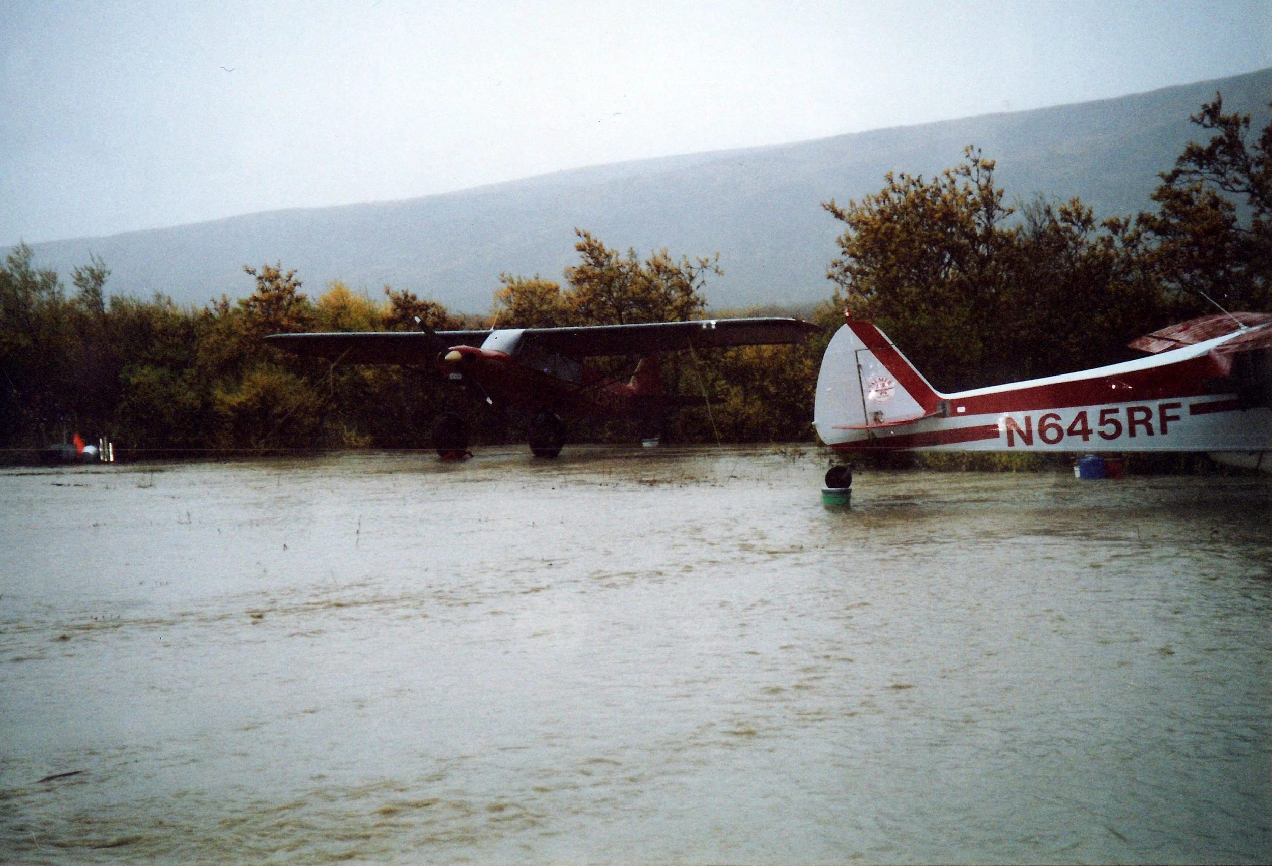 Planes on crates and buckets during one of the Dog Salmon River floods.