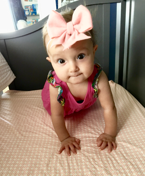 Hanging out in the crib wearing a Lilly Belle Market 4" pale pink Lucy felt bow.
