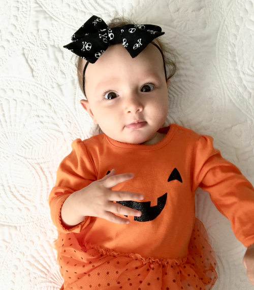 Sporting a black and white skull bow from Posh Pelican Co. 