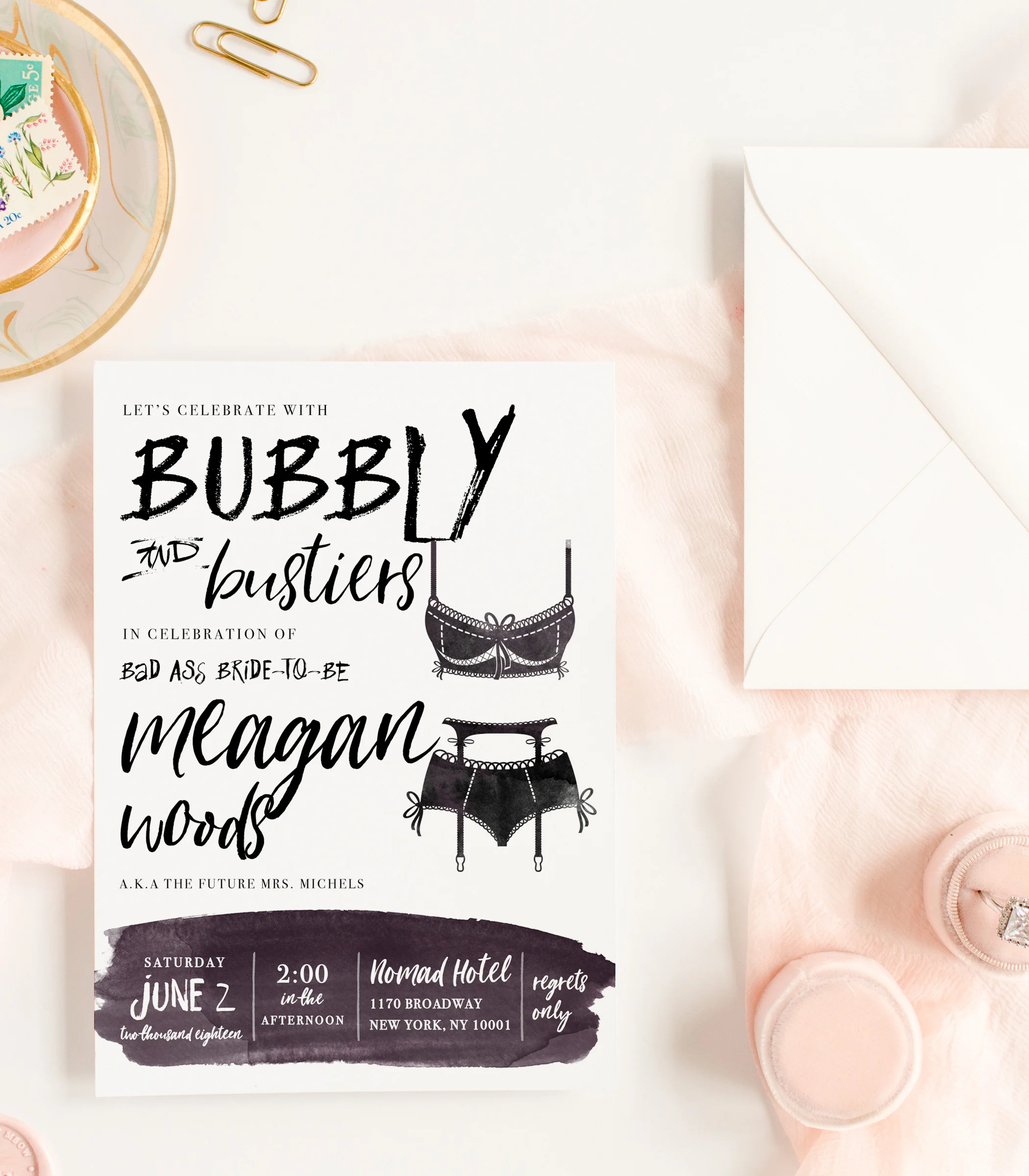 Flatlay of Black white gray Lingerie Bustiers and Champagne Bridal Shower Invitations