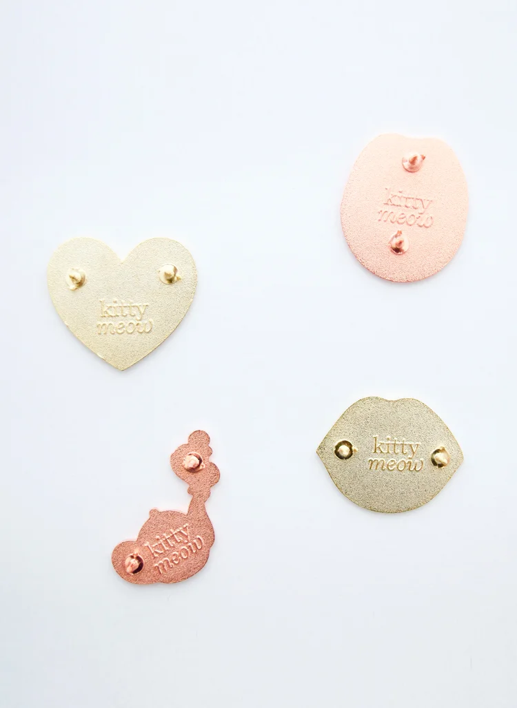 Copy of kitty meow logo stamped on set of enamel pins