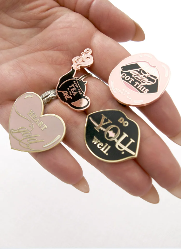 Copy of kitty meow boutique inspirational enamel pin collection shown on hand