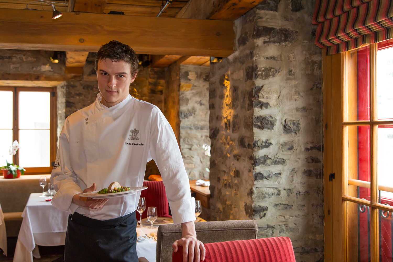  Restaurant waiter serving food on platter in restaurant. Lifestyle food photography by Susan Seubert. 
