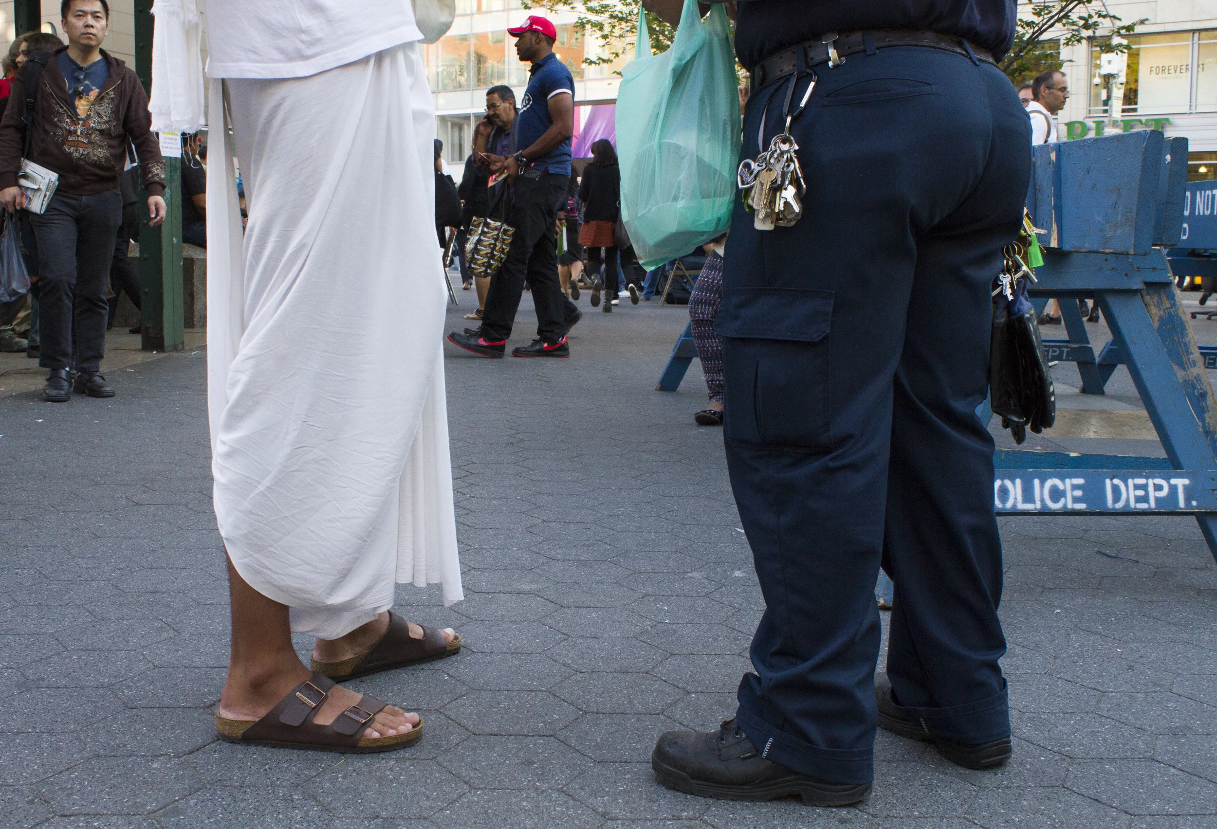 Hare Krishna monk Alex Seibel, 19, speaks with a security guard in Union Square, where he hands out books and chants most days. 