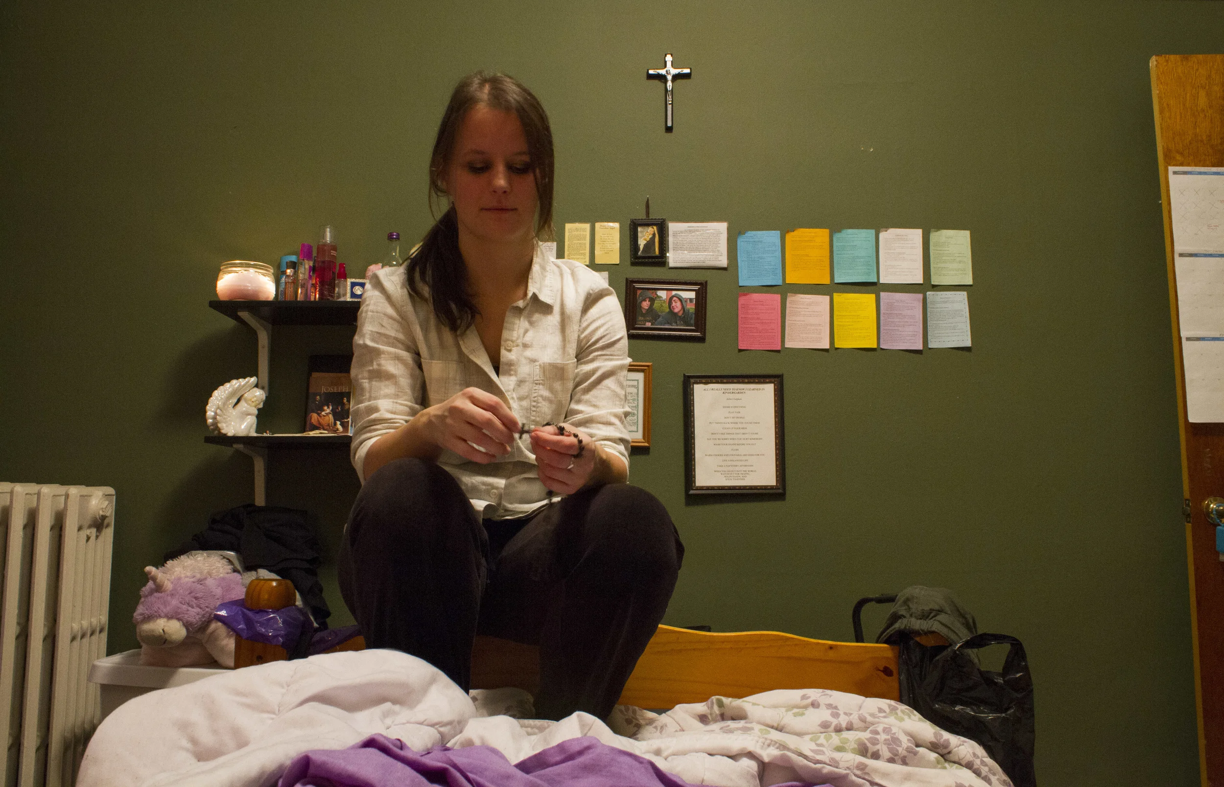 Catholic Minister Melissa McChesney, 24, holds rosary beads before evening prayers. 