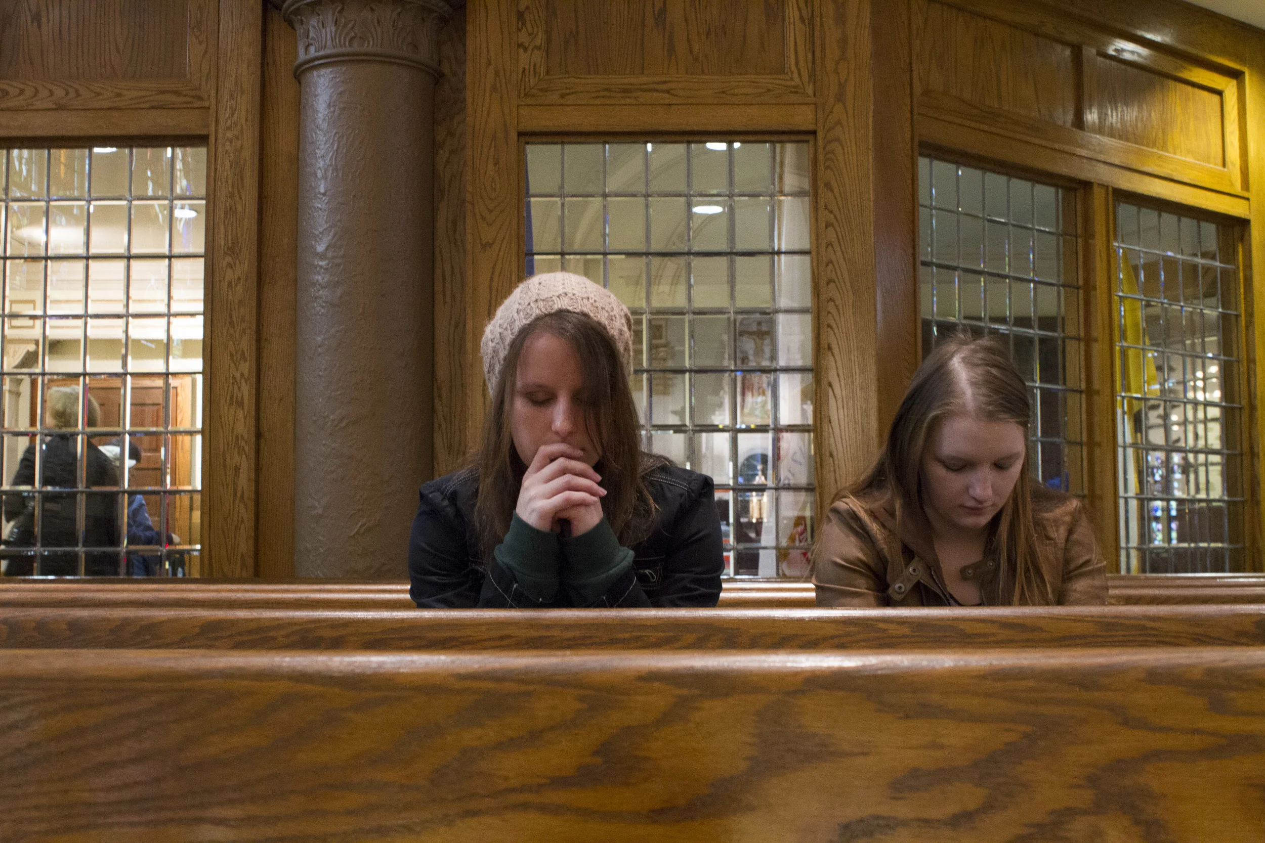 Catholic Minister Melissa McChesney, 24, prays at noon mass with her sister. 