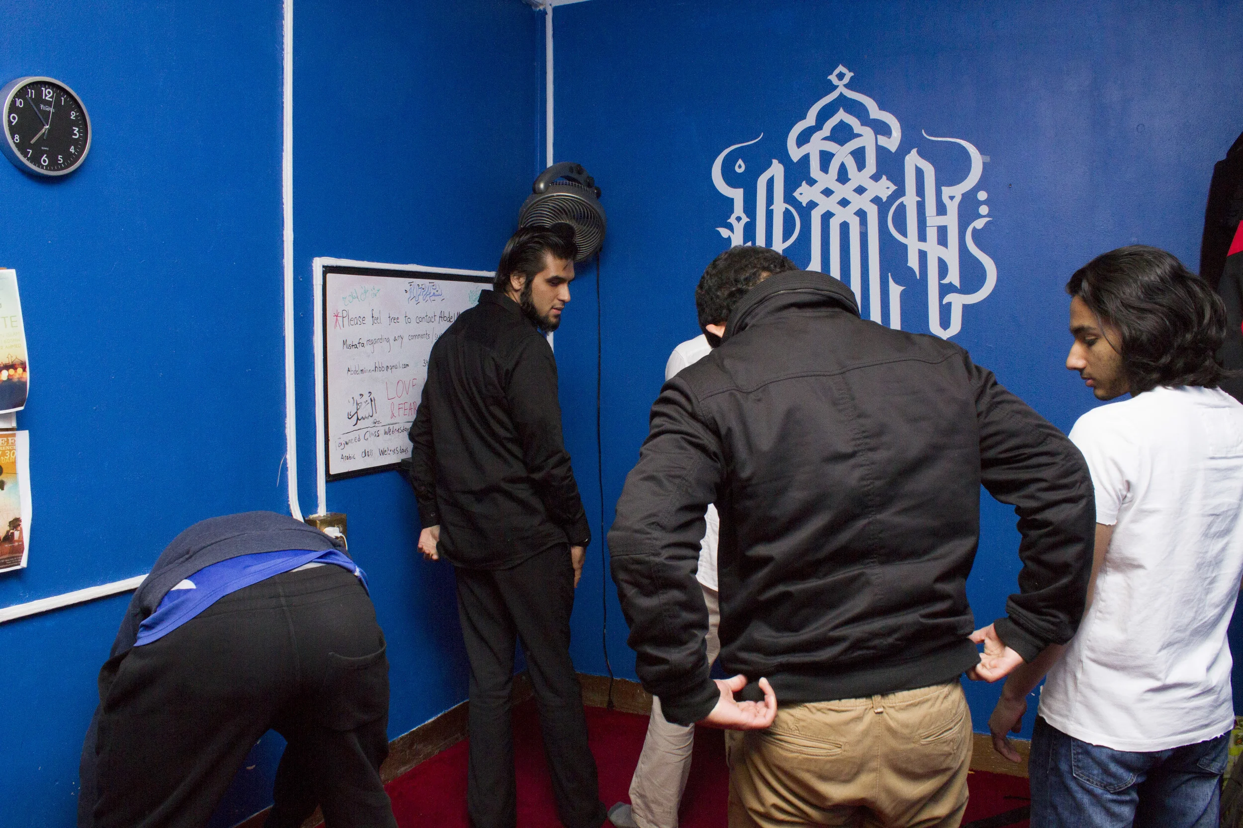 Navel Shah, 19, prays inside the school's Muslim prayer room.