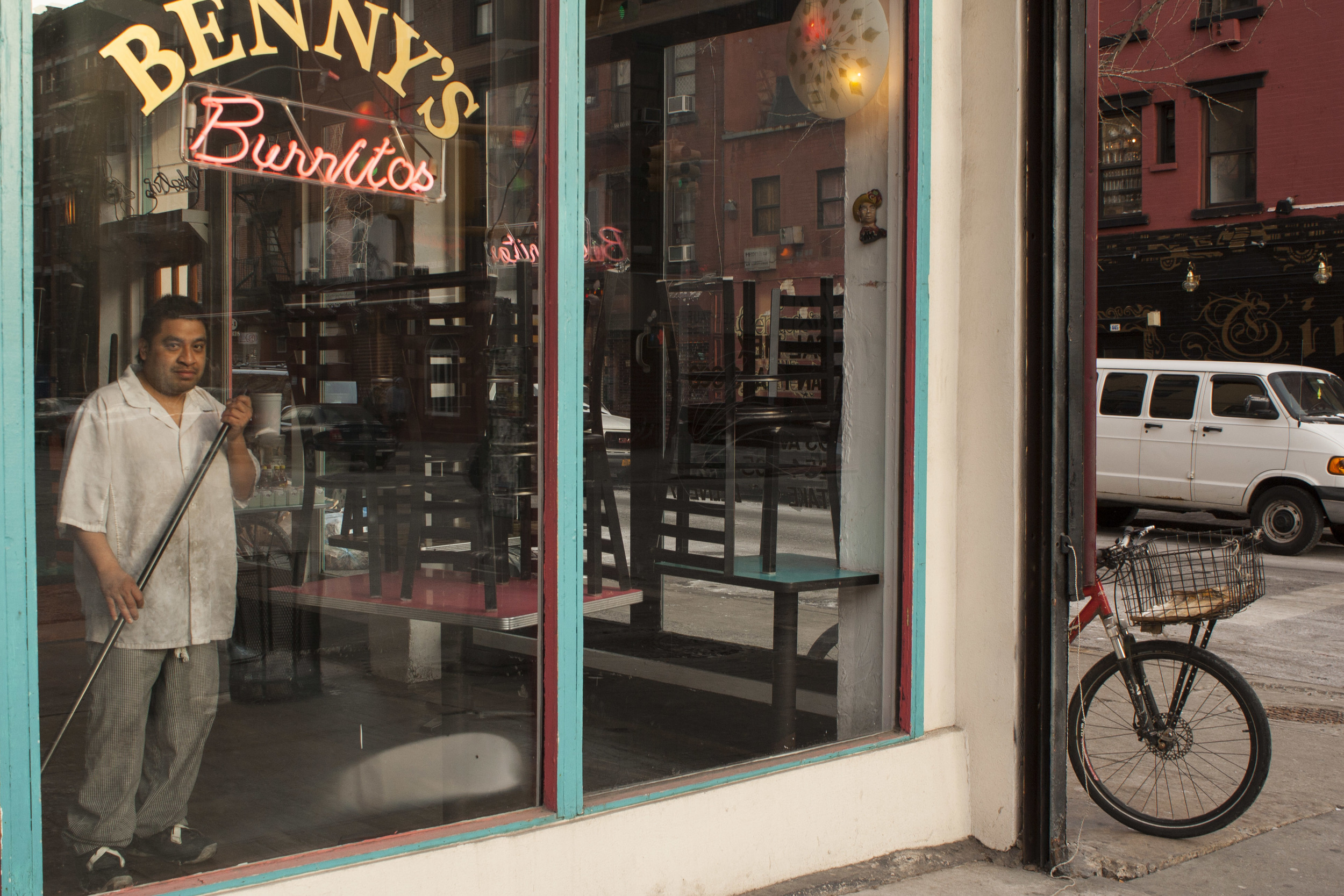 An employee at Benny's Burritos cleans before opening. 