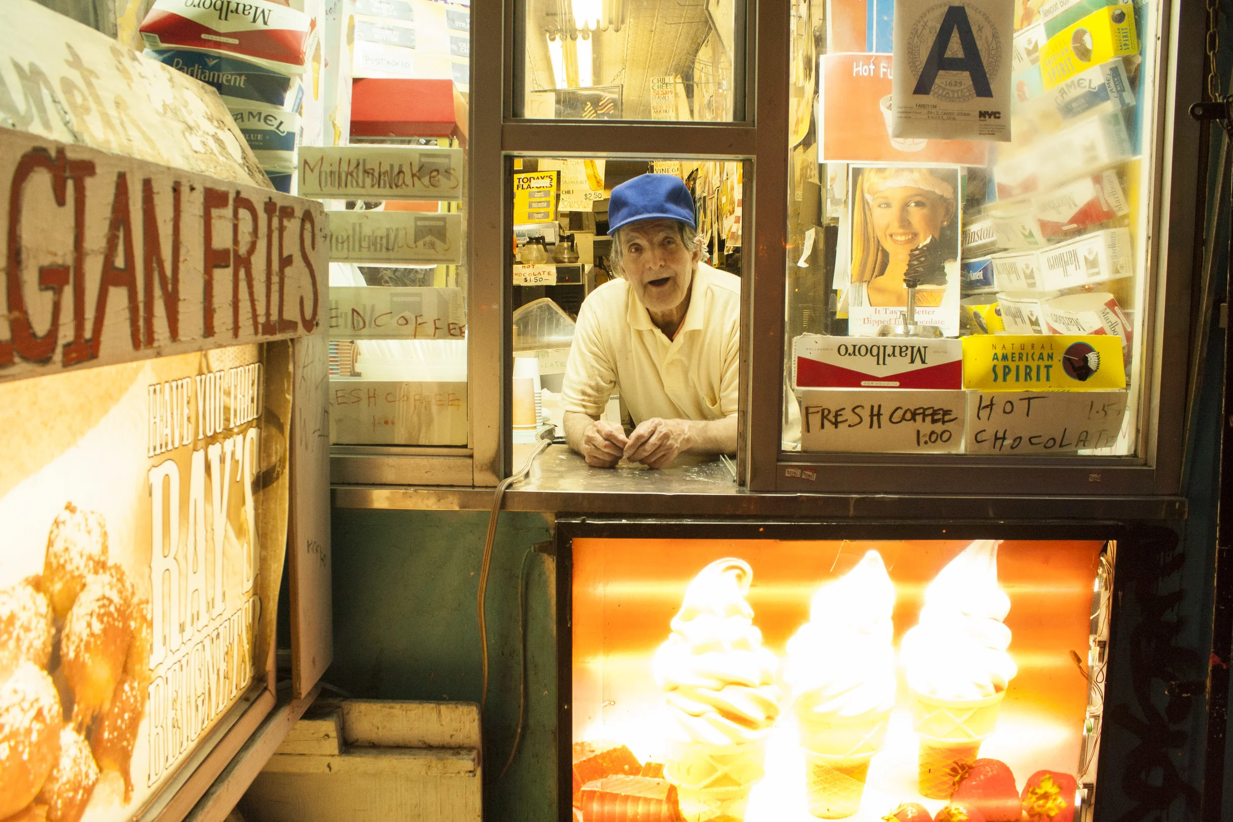 Ray Alvarez looks out the window of Ray's Candy Store, an institution since 1974. Alvarez, an Iranian immigrant, has nearly being evicted in the past, but locals have fundraised to keep him in business. 