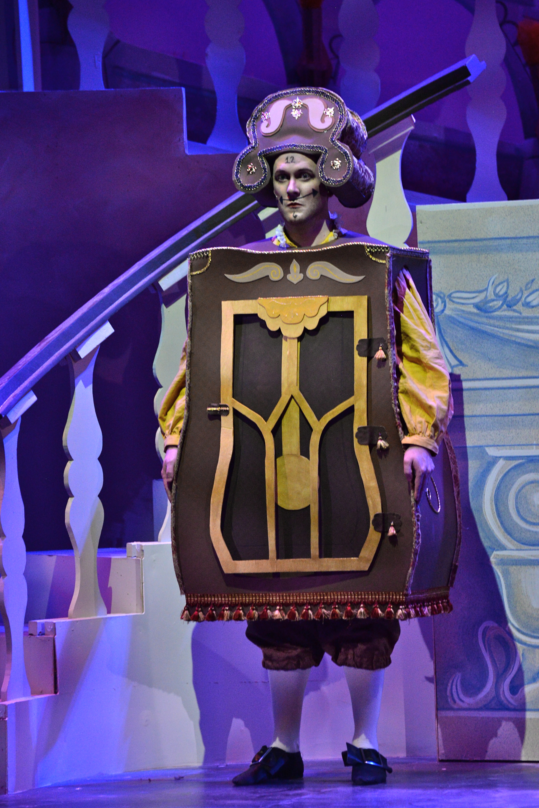 Cogsworth stands, trying to go unnoticed.