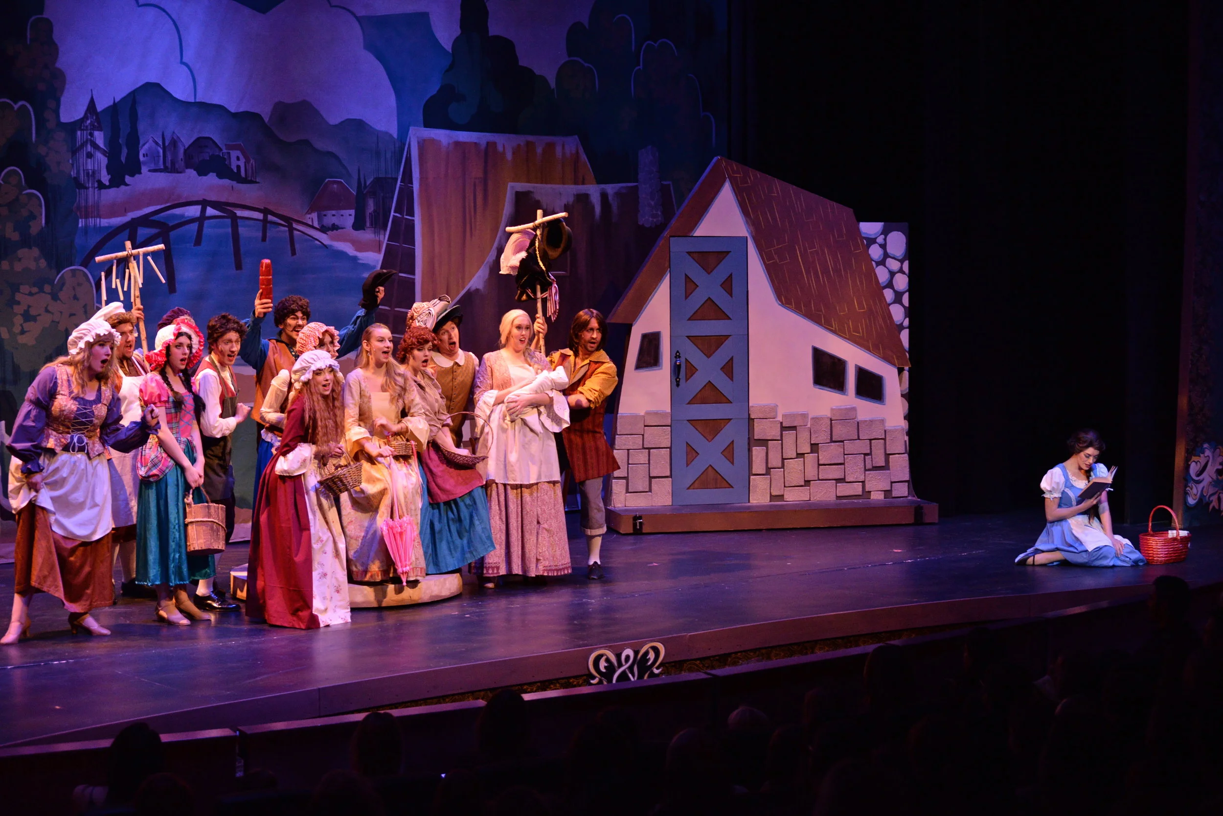 Belle reads as the townsfolk marvel in confusion during "Belle".