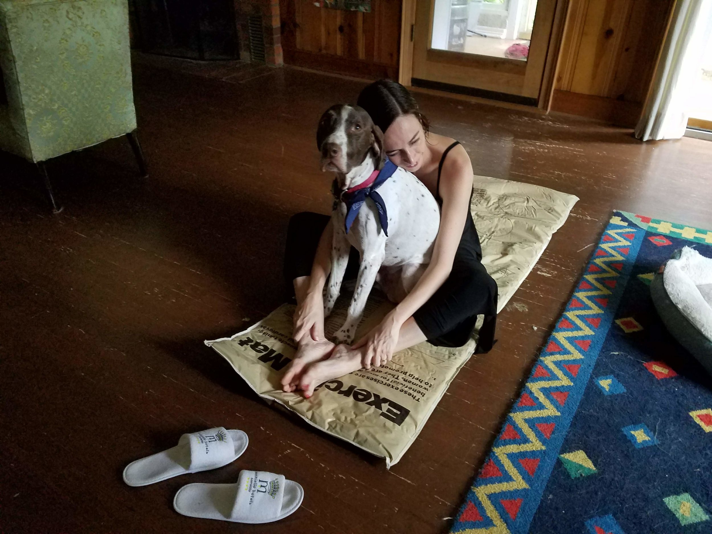 Stone, Security Manager, assisting Nuria Martinez with her stretching exercises.